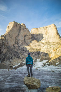 Rear view of man standing on rock