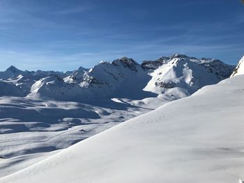 Scenic view of snowcapped mountains against sky