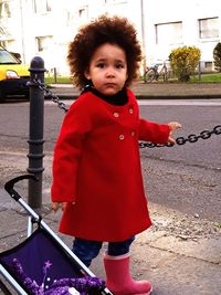 Portrait of cute girl standing in city