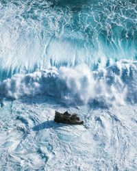 High angle view of waves splashing on sea