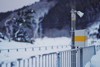 Close-up of arrow sign on snow