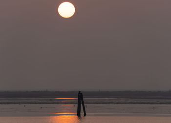 Scenic view of sea against clear sky at sunset