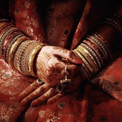 Midsection of bride wearing bangles