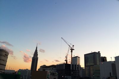 Silhouette of buildings against sky at sunset
