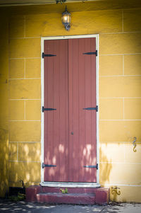 Sunlight on closed brown door of house