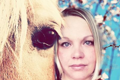 Close-up portrait of woman with horse