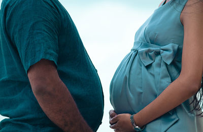 Midsection of couple holding hands