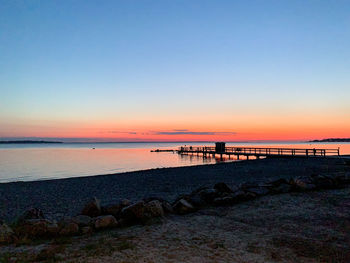 Scenic view of sea against clear sky during sunset