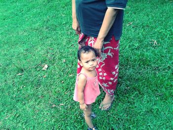 Girl standing on grassy field