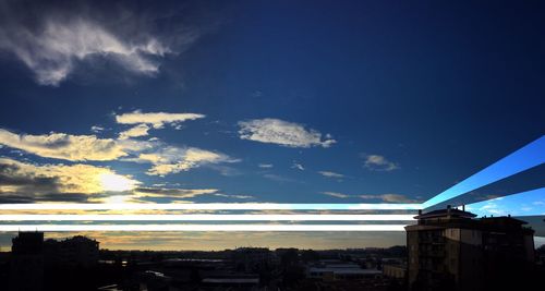 View of cityscape against cloudy sky