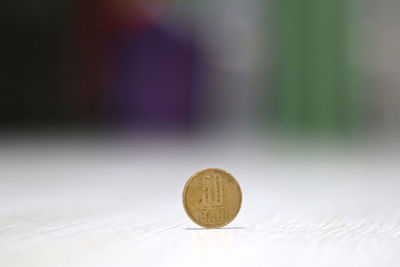 Close-up of golden coin on table