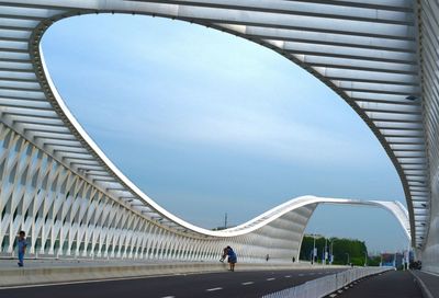 Low angle view of modern bridge against sky