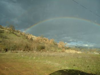 Scenic view of rainbow over field
