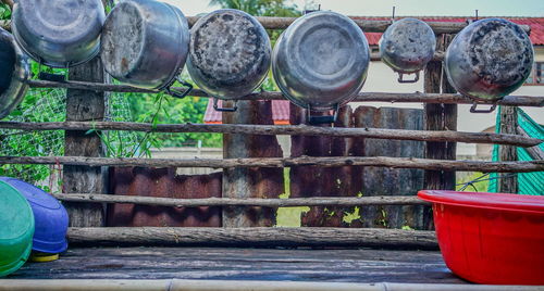 Close-up of old metal container against building