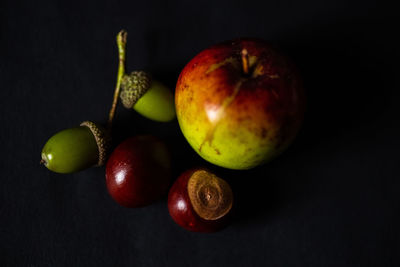 Close-up of apples on table against black background