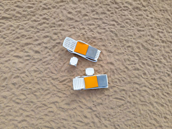 Sunbeds tables on the lonely sand sea beach