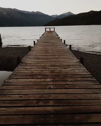 Pier over lake against mountains