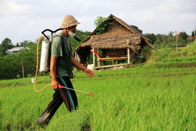 Rear view of man working on field