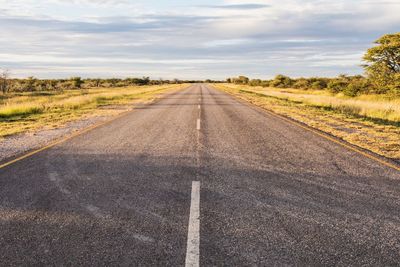 Road by landscape against sky