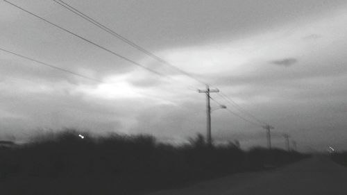 Low angle view of electricity pylon against sky