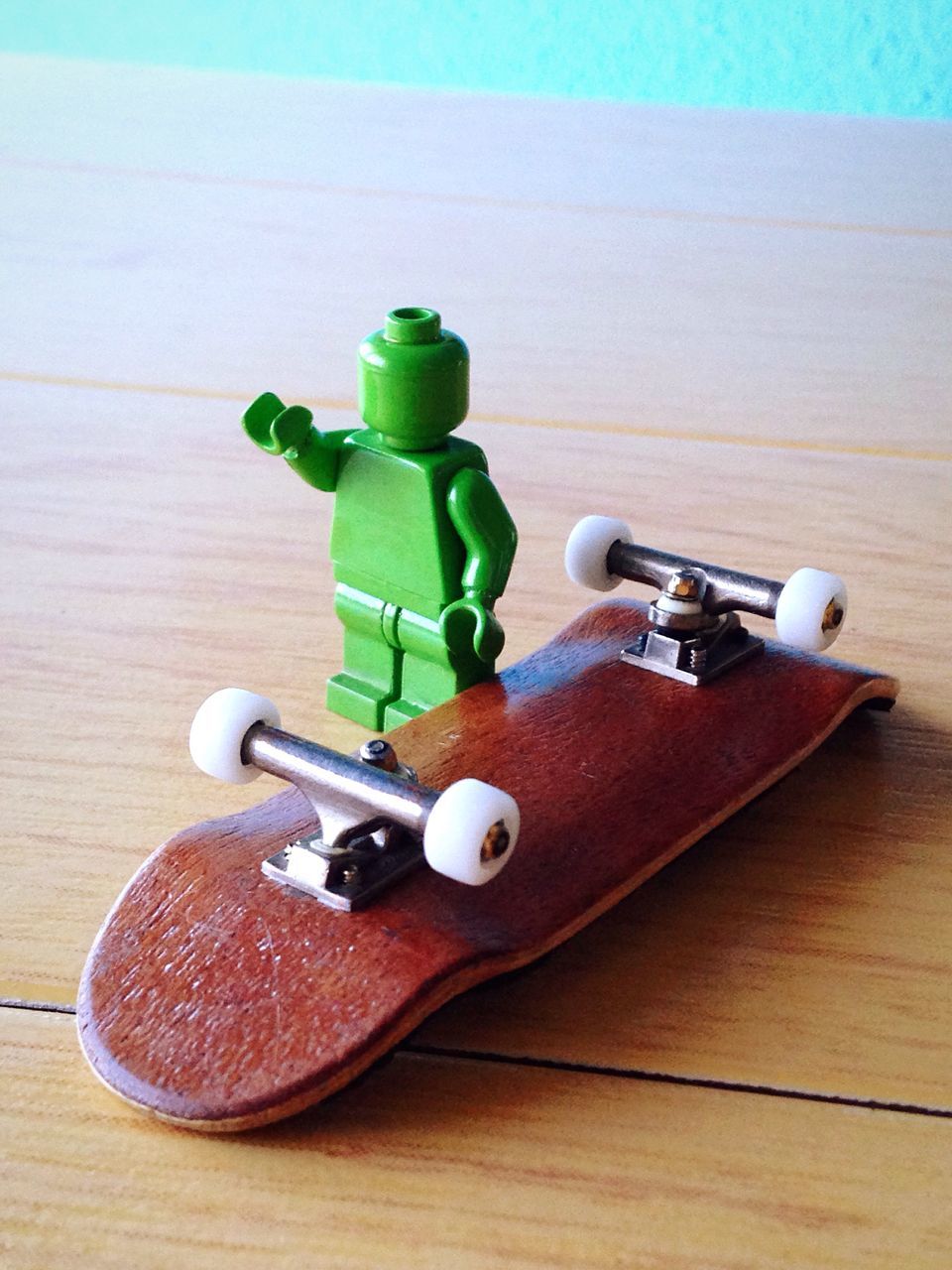 table, still life, wood - material, indoors, green color, high angle view, wooden, close-up, no people, food and drink, wood, toy, day, technology, single object, equipment, freshness, absence, shadow, sunlight