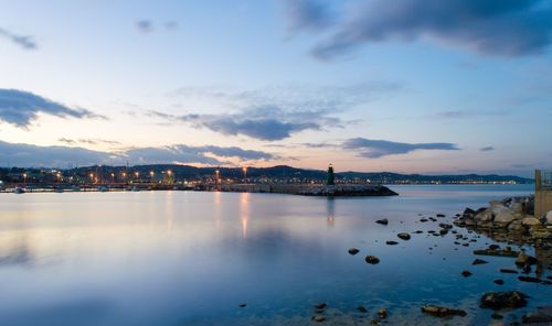 Scenic view of sea against sky in city