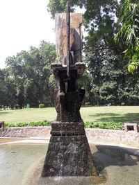 Statue in park against sky