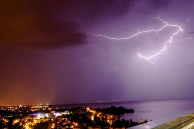 Storm clouds over city at night