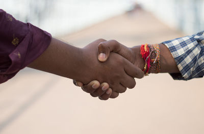 Midsection of man holding hands