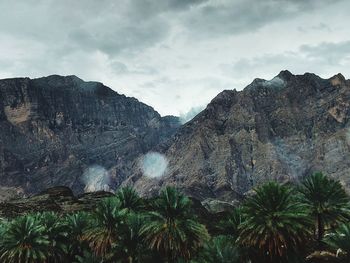 Low angle view of rocky mountains against sky