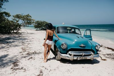 Woman on beach against sky