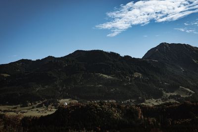 Scenic view of mountains against blue sky