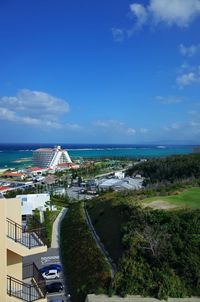 Scenic view of sea by buildings against sky