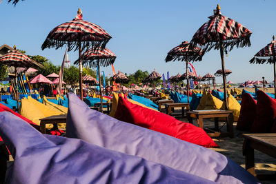 Lounge chairs and umbrellas on beach against sky at seminyak bali indonesia