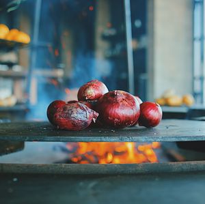 Close-up of onions on cooking pan over fire