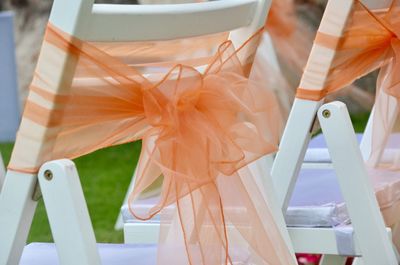 Close up of fabric tied on chairs at wedding