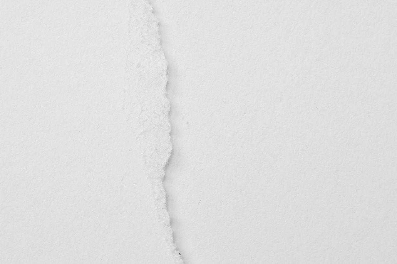 HIGH ANGLE VIEW OF WHITE PAPER AGAINST WALL