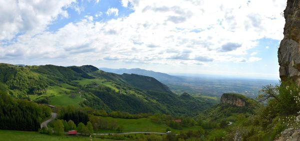 Scenic view of mountains against cloudy sky