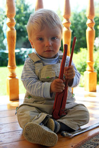 Portrait of cute boy sitting outdoors