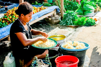 Young man preparing food at market