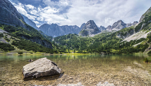 Scenic view of lake and mountains against sky