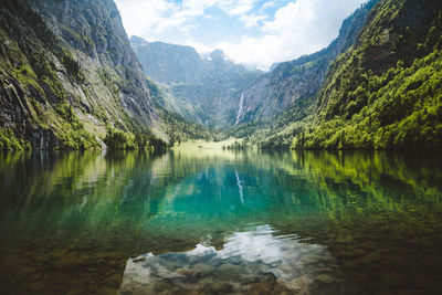 Scenic view of lake and mountains against sky