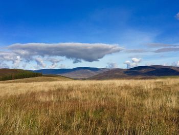 View of countryside landscape against cloudy sky