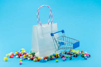 Low angle view of candies against blue background