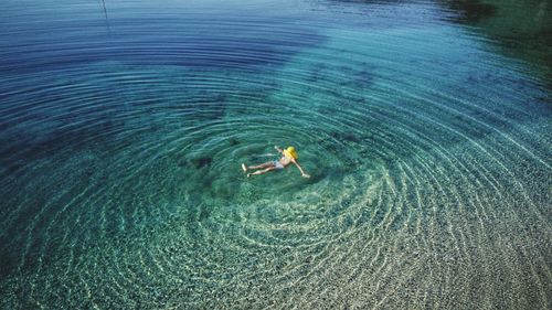 High angle view of woman swimming in sea