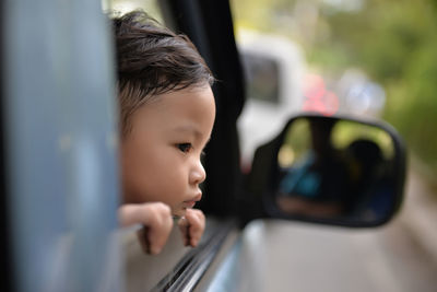 Close-up portrait of young woman in car