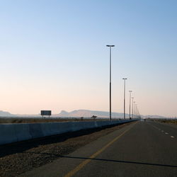 Empty road against clear sky