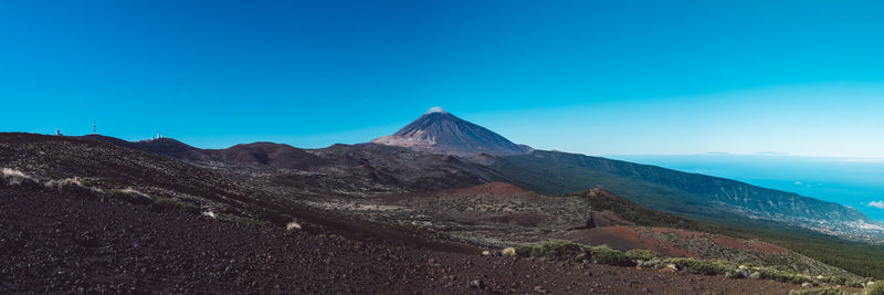 View of volcanic mountain against blue sky