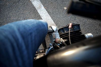 Low section of man playing guitar on street
