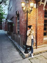 People standing on footpath by building